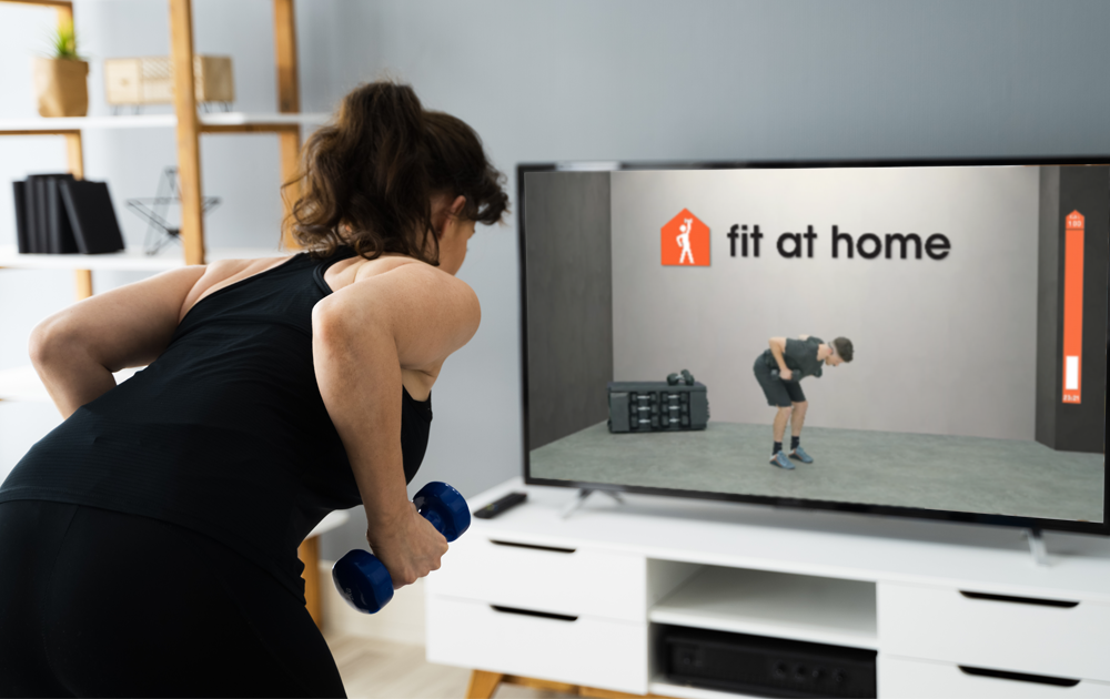 Woman is doing a Dumbbell & Fit wotkout at home with Fit at Home