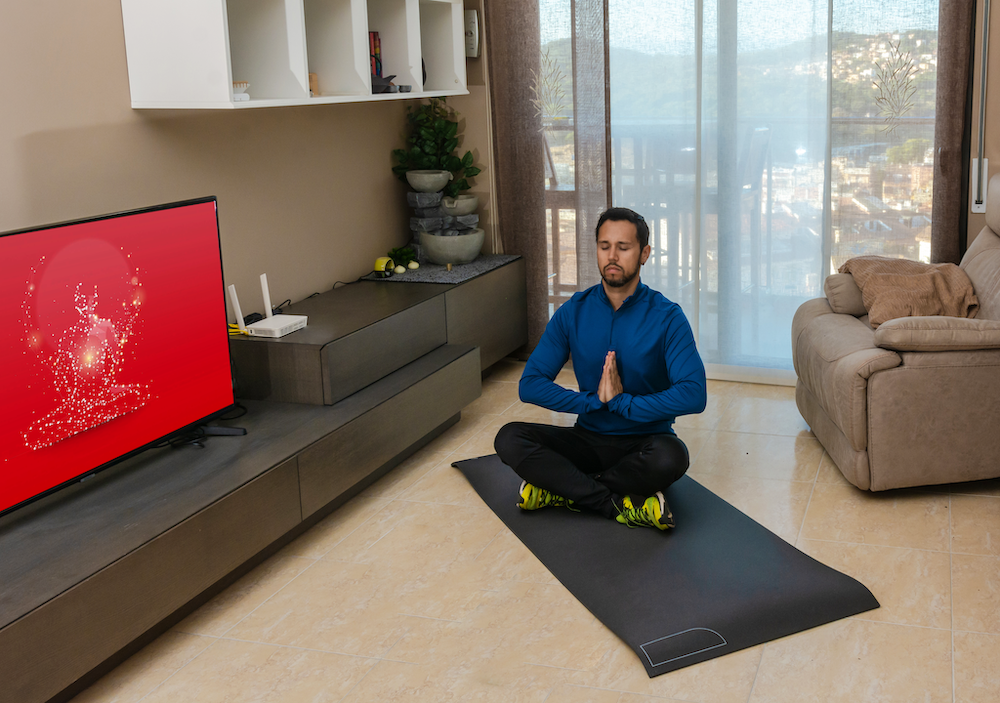 Man doing a Meditation & Fit lesson at home
