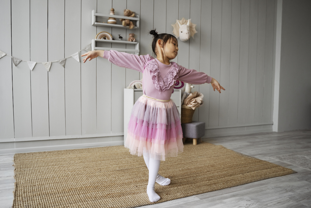 Young girl dances at home