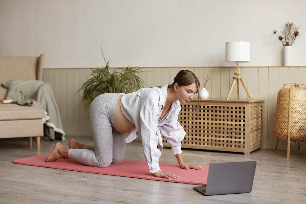 Pregnant woman exercising at home
