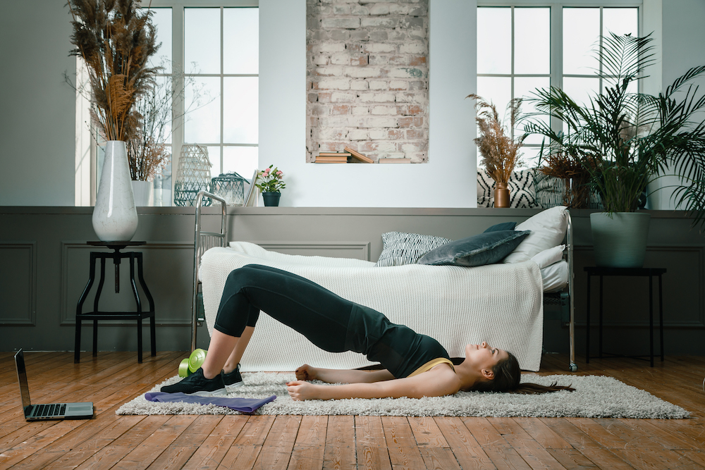 Woman doing a pilates plank exercise at home