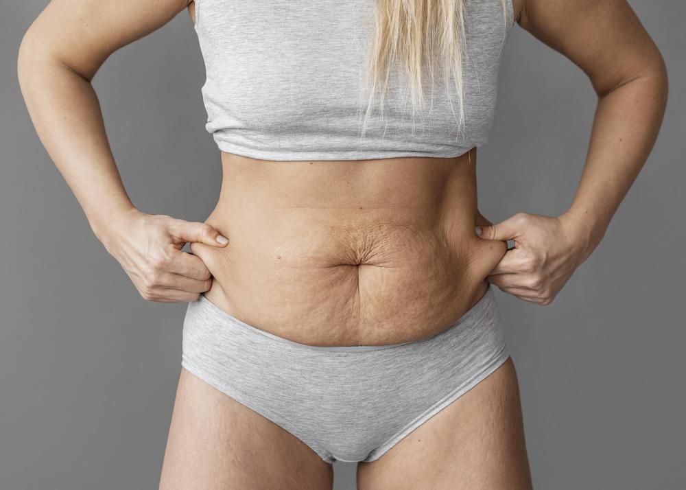 https://staging.fitathome.com/wp-content/uploads/2023/08/close-up-woman-holding-belly-fat.jpg